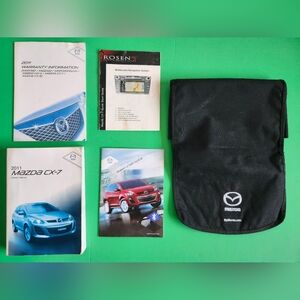 2011 Mazda CX-7 owner's manual set, which includes the main manual, warranty inf